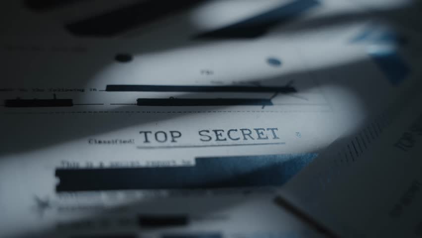 Extreme close up on top secret labeled document with classified censored text. Retro looking paper marked as secret and with sensitive government agency blacked out information and intelligence data