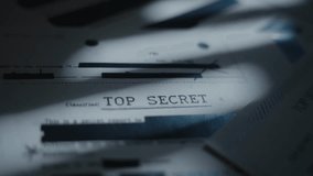 Extreme close up on top secret labeled document with classified censored text. Retro looking paper marked as secret and with sensitive government agency blacked out information and intelligence data - Powered by Shutterstock - Get 15% off with code: PIKWIZARD15