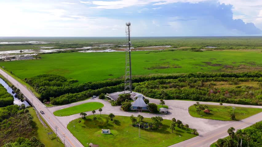 Aerial video entrance to Big Cypress National Preserve. View of everglades and cell tower