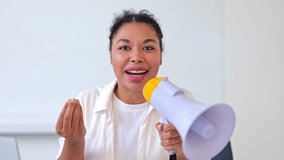 Excited professional businesswoman, dressed in white, uses megaphone indoors. Cheerful specialist delivers important message, engaging audience with confident, happy expression. - Powered by Shutterstock - Get 15% off with code: PIKWIZARD15