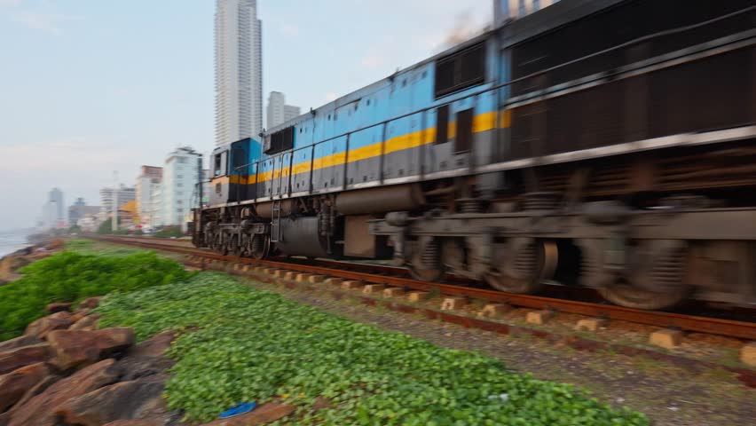 Train on Colombo beach in Sri Lanka on sunset period.