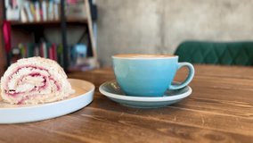 A Delightful and Delicious Coffee Alongside an Amazing Dessert Experience Awaiting You. A beautifully crafted latte alongside a delicious pastry resting on a warm wooden table, ideal for cafe goers. - Powered by Shutterstock - Get 15% off with code: PIKWIZARD15