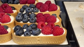 Enjoy a delicious Berry Tart with creamy filling and fresh fruits, ideal for any occasion. A delectable dessert made with a tart shell, creamy filling, blueberries, as well as fresh raspberries. - Powered by Shutterstock - Get 15% off with code: PIKWIZARD15