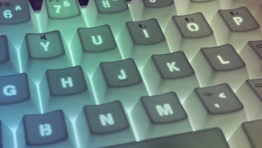 Close-up video of mechanical computer keyboard with RGB backlight changing colors, glowing keys with neon light effect, abstract background for gaming, technology and modern digital lifestyle concept. - Powered by Shutterstock - Get 15% off with code: PIKWIZARD15