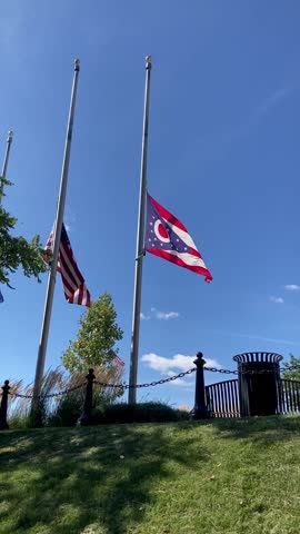 American flag and Ohio flag at half-staff