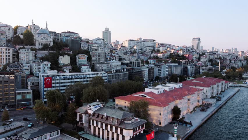 Istanbul, Turkey - July 18, 2025: Panoramic view of Istanbul in evening. View of passenger port, pedestrian embankment, residential buildings and mosques, Turkey. handheld. High quality 4k footage