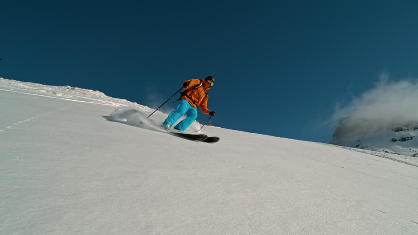 Skier riding in the scenic Dolomites mountains in fresh powder snow. Super slow motion at 1000 fps.