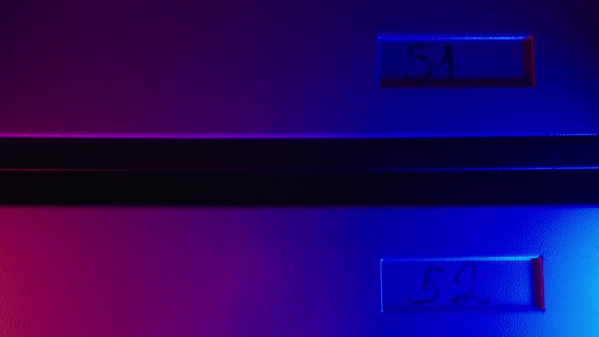 Apartment Mailboxes with Unit Numbers in Modern Residential Building | Blue and Red LED Lighting | Slow Top-Down Camera Movement