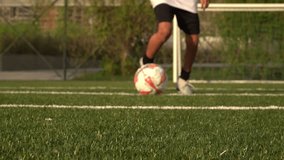 A close-up view of a soccer ball being kicked on a lush green turf field. The focus is on the motion of the ball and the foot of the player, emphasizing the sport of soccer. - Powered by Shutterstock - Get 15% off with code: PIKWIZARD15