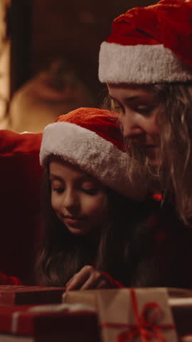 Magical holiday campaign scene with family opening glowing gift