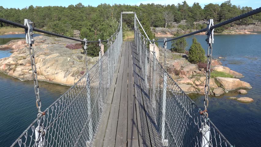 Stendorren, Sweden A pedestrian bridge in the Stendorren Nature Reserve to a rocky island in the Baltic Sea.