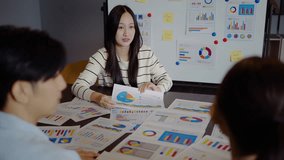 Asian businesswoman startup presenting data chart project management meeting with colleagues, financial report analysis teamwork strategy plan corporate success at office, marketing, data analytics - Powered by Shutterstock - Get 15% off with code: PIKWIZARD15