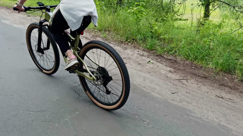 Female Cyclist Biking On Rural Path. Outdoor Ride Fitness Training In Nature Active Lifestyle Sport. Outdoor Recreation Activity. Trail Riding. Mountain Biking Cycling. Cyclist Cardio Training Cycling