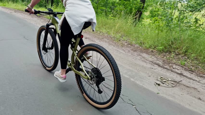 Female Cyclist Biking On Rural Path. Outdoor Ride Fitness Training In Nature Active Lifestyle Sport. Outdoor Recreation Activity. Trail Riding. Mountain Biking Cycling. Cyclist Cardio Training Cycling
