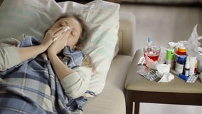 Sick Woman Resting On Sofa. Female With Flu Or Cold Symptoms, Illness And Home Sickness. Blowing Nose With Tissue. Common Ailments. Seasonal Sickness, Flu Season. Health Issues, Sore Throat Sickness - Powered by Shutterstock - Get 15% off with code: PIKWIZARD15