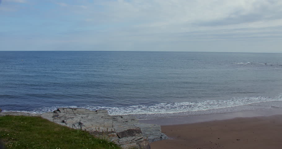 Wide shot looking out to sea at Aberporth bay