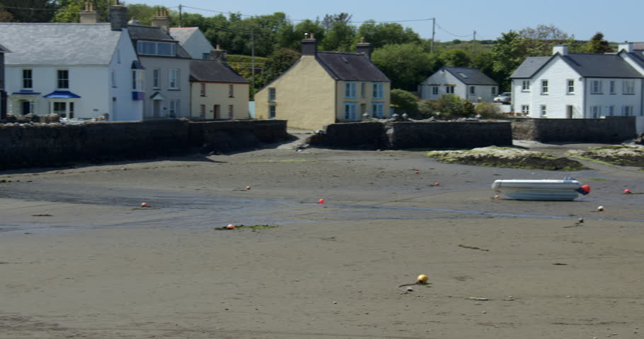 Panning shot of Parrog beach and river Nyfer at Newport sands. With cars and boats