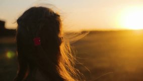 Girl Watching Sunset in Nature. Silhouette woman with Braided Clip Hair Standing in Golden Field at Sunrise, Peaceful Countryside Scene with Warm Sunlight and Lens Flare. female sun rays outdoor - Powered by Shutterstock - Get 15% off with code: PIKWIZARD15