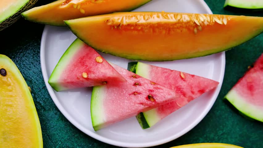 Melon slices, cantaloupe, watermelon, fresh fruit on a plate, summer food