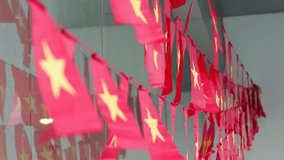 A line of red and yellow star pennant flags hanging indoors as a festive decoration. - Powered by Shutterstock - Get 15% off with code: PIKWIZARD15