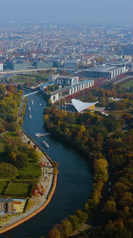 Vertical 4K drone video over Berlin’s government district : Spree River, Federal Chancellery and Haus der Kulturen der Welt framed by autumn Tiergarten - mobile first aerial for travel and editorial.