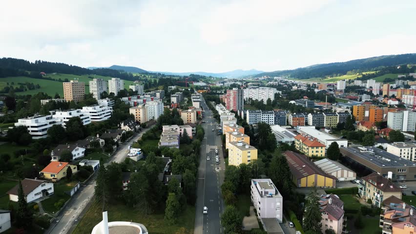 Aerial view of the cityscape showing building rooftops, roads, and greenery blending together in La Chaux-de-Fonds, Neuchâtel, Switzerland.