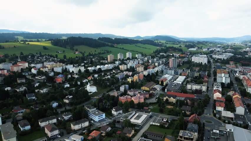 Aerial view of buildings and landscape with contrasting colors and textures, creating a visually immersive experience, La Chaux-de-Fonds, Neuchâtel, Switzerland.