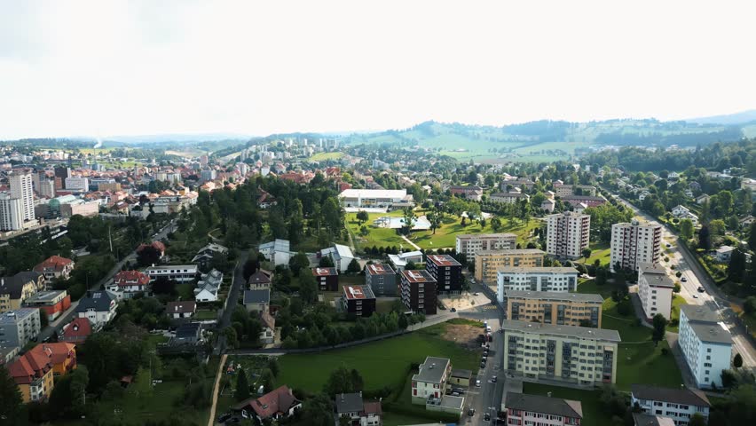 Aerial view of buildings, green spaces and roads blend together harmoniously in La Chaux-de-Fonds, creating a vibrant urban landscape, La Chaux-de-Fonds, Neuchâtel, Switzerland.