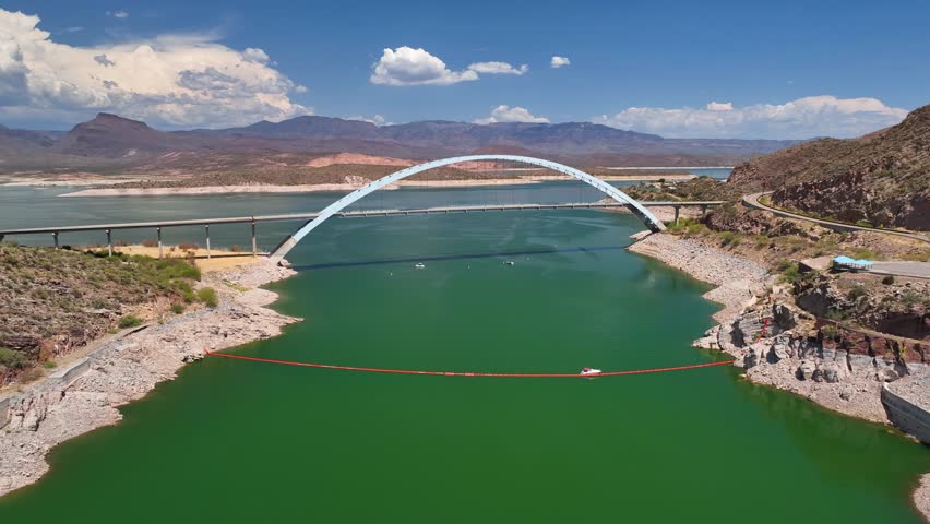 Aerial view of the Theodore Roosevelt Dam and bridge, with the lake