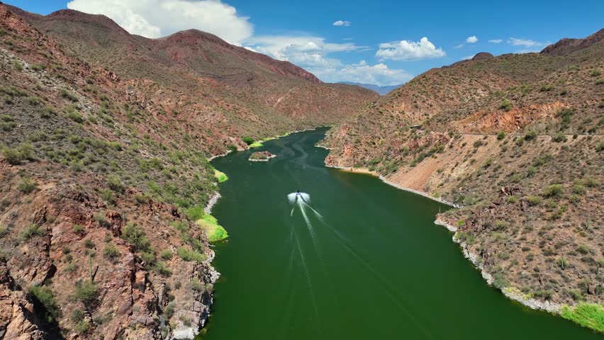 Aerial view of the tranquil, emerald-green waters and the rugged, rocky landscape of Theodore Roosevelt Lake, Arizona, United States.