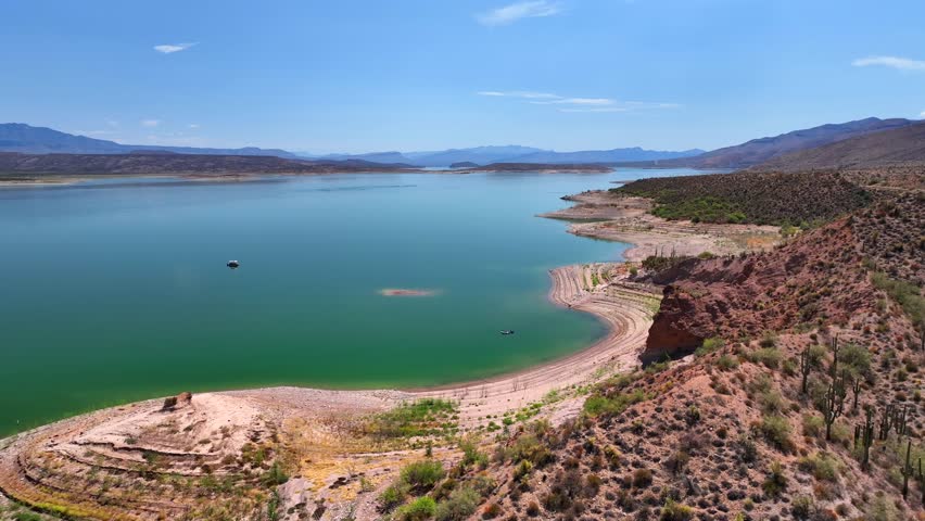 Aerial view of the expansive Theodore Roosevelt lake with its green waters contrasting with the red banks, Theodore Roosevelt lake, Arizona, United States.