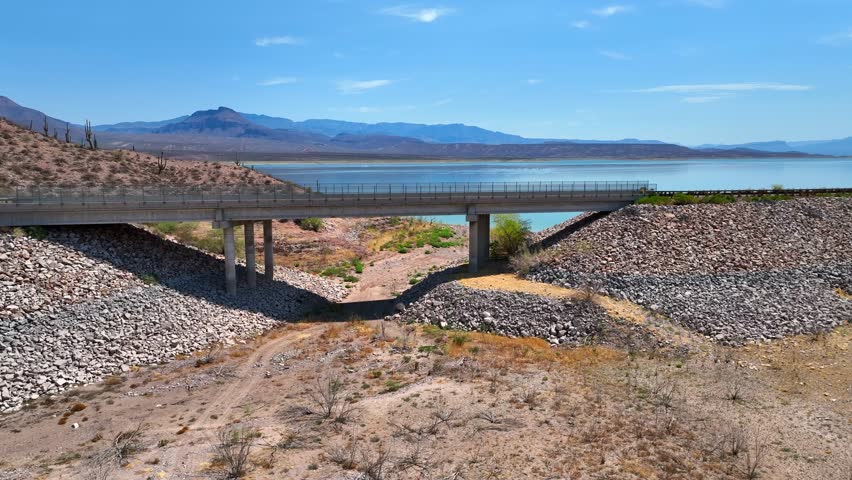Aerial view of the bridge over the river with mountains and clear blue sky, Theodore Roosevelt lake, Arizona, United States.