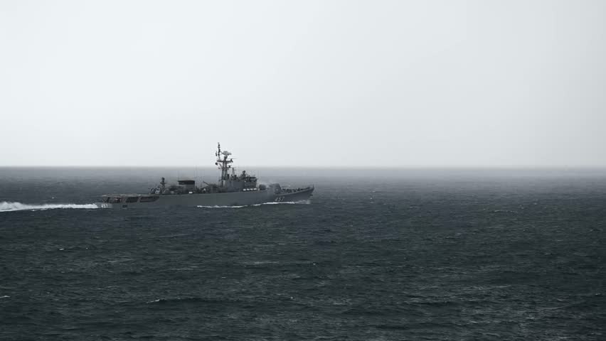 Armed navy patrol ship cruising deep blue sea. High quality 4k footage
