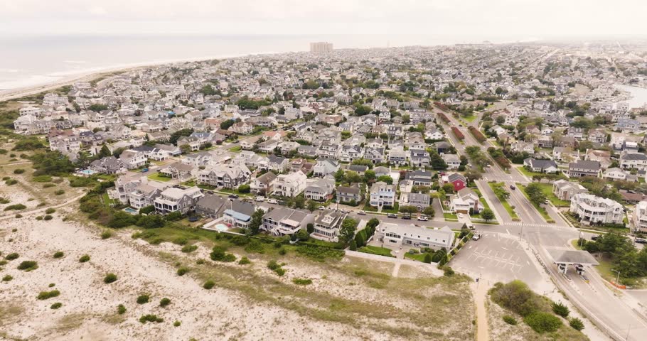 Drone shot of Ocean City New Jersey before sunset of vacation homes in expensive neighborhoods.