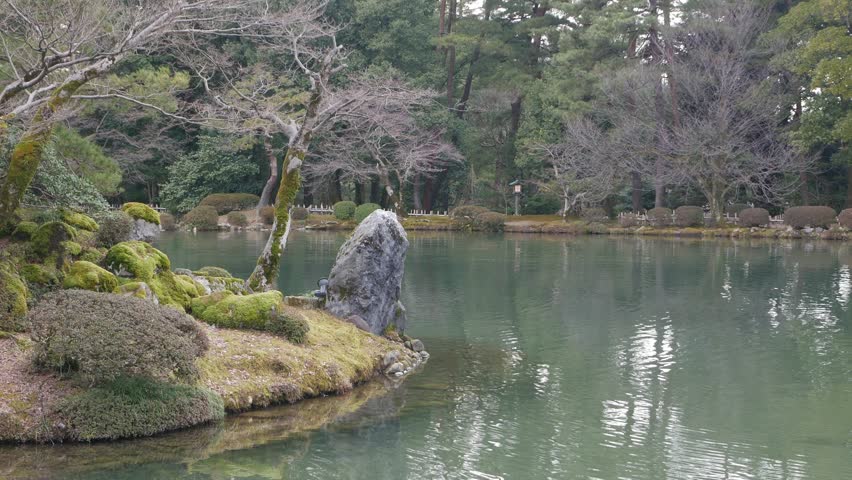 pond lake landscape and many kind of tree in japanese garden zen style with island in the pond in garden.natural zen garden environment landscape background in winter time
