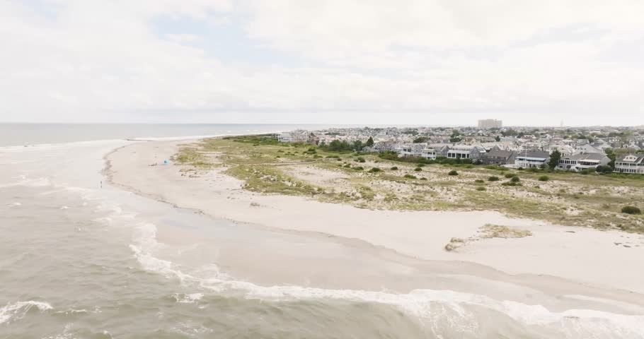 Aerial view of Ocean City New Jersey beach over the Atlantic Ocean on a cloudy bright day