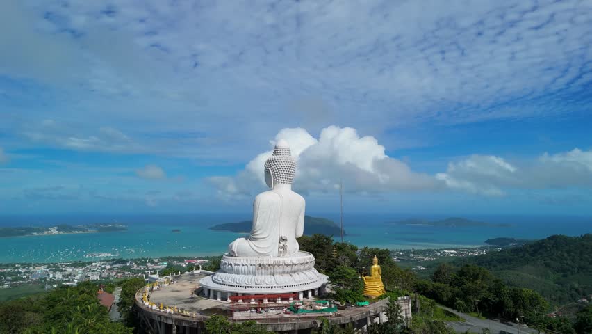 Aerial slow orbit left circles Phuket Big Buddha on Khao Nakkerd with Andaman views