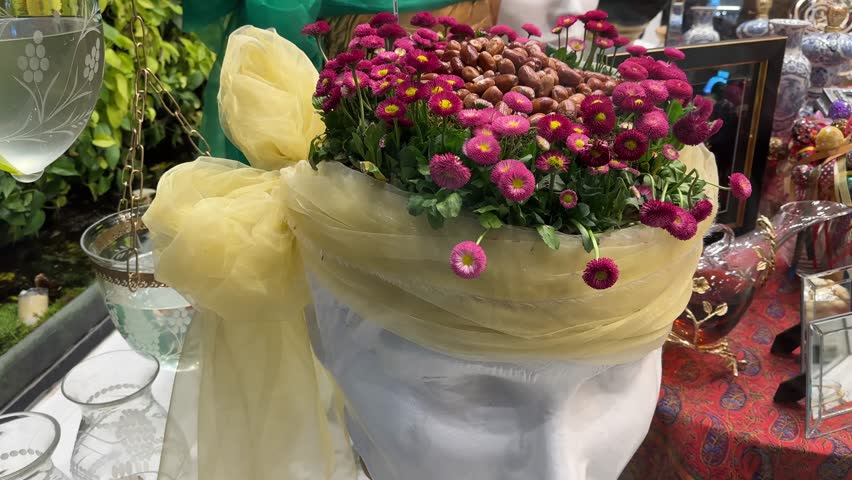 Fresh flower design on colorful scenic dining table of Haftsin New Year Nowruz Tehran Iran family gathering celebration green garlic samanu nuts candle clock countdown culture traditional decoration