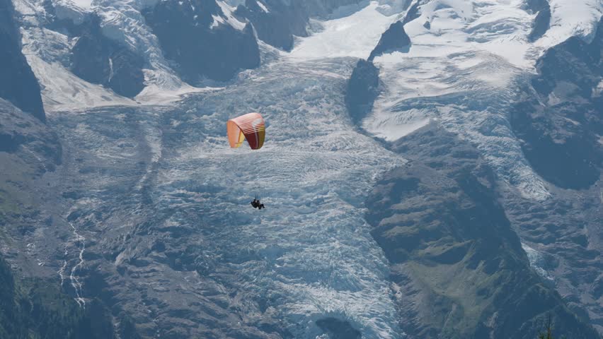 Paragliding in Chamonix Valley with tandem wing in the shadow of Mont Blanc the tallest peak in western Europe