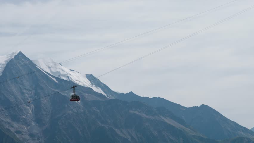 Gondola car to Brevent crosses in front of the Mont Blanc Massif in Chamonix Valley France