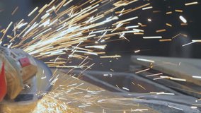 Worker preparation steel plate by hand grinding machine. A worker grinds a metal plate or part with a hand grinder. Worker Grinding Metal Plate. The metalworking shop. Sparks slowmotion, close-up - Powered by Shutterstock - Get 15% off with code: PIKWIZARD15