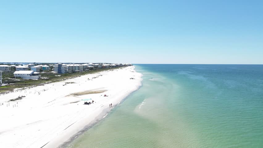 Forward drone movement over the wide sandy beach side of Cape San Blas with turquoise ocean, Gulf County, Florida, USA