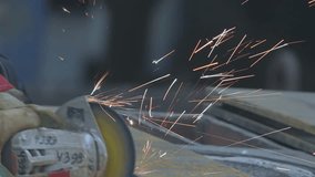 Worker Grinding Metal Plate. Steel structure metalworking shop. A worker grinds a metal plate or sheet with a hand grinder. Worker preparation steel plate by hand grinding machine. Sparks close-up - Powered by Shutterstock - Get 15% off with code: PIKWIZARD15