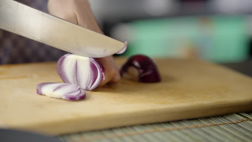 Cutting Fresh Red Onion With Sharp Kitchen Knife. Cooking Process And Culinary Preparation. Healthy Ingredients Red Onion. Homemade Recipe With Organic Onion Slices. Food Ingredient Preparation Knife