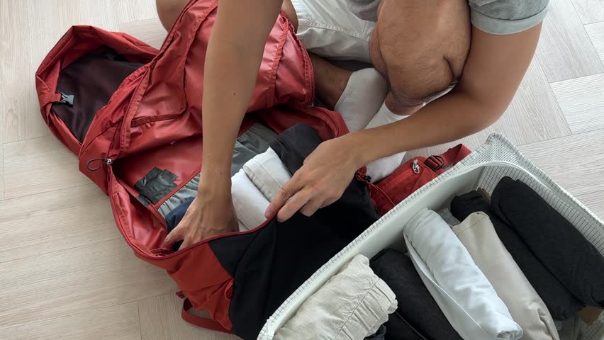 Packing clothes efficiently in backpack maximizes space and minimizes wrinkles during travel preparations