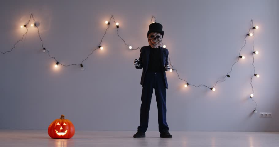 Halloween happy holiday funny kid scary skeleton dance, zombie costume dress ups party night event, role playing carnival, spooky black monster horror cosplay, holiday garland light, pumpkin lantern