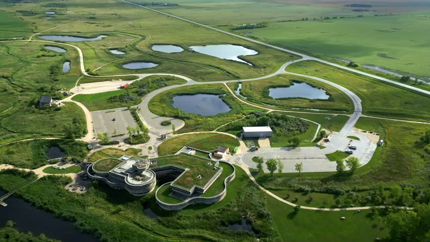Futuristic green-roof centre mapped from above with roads, paths, wetlands