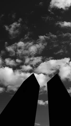 Silhouette of Towers on background of black and white sky. 09.11.2001 American Patriot Day video. Vertical video with inscription for social media and stories.