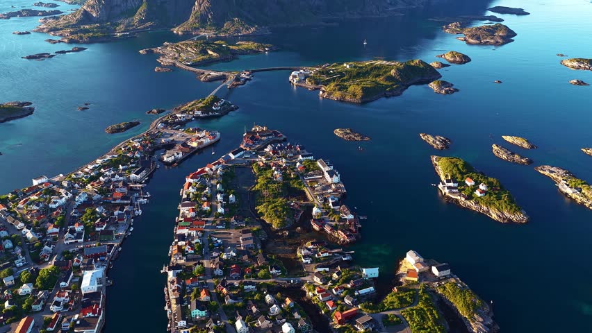 Reinebringen mountain looming over picturesque fishing village of reine, norway