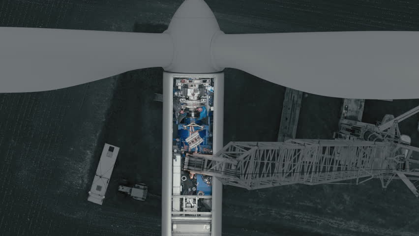 aerial close up view crane lifting wind turbine